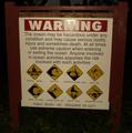 [Photo of beach warning sign]