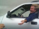 [Photo of Roger reaching for candy while driving]