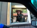 [Photo of a park ranger smiling]